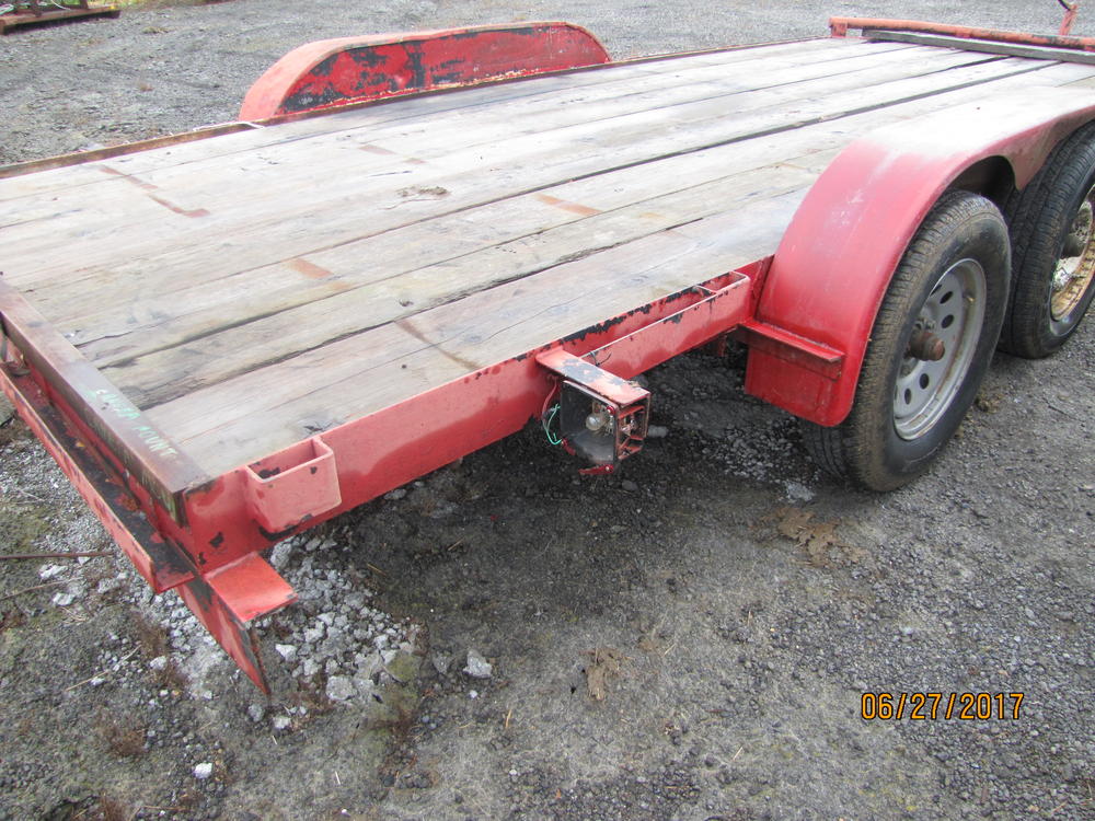 Back of a red flat bed trailer.