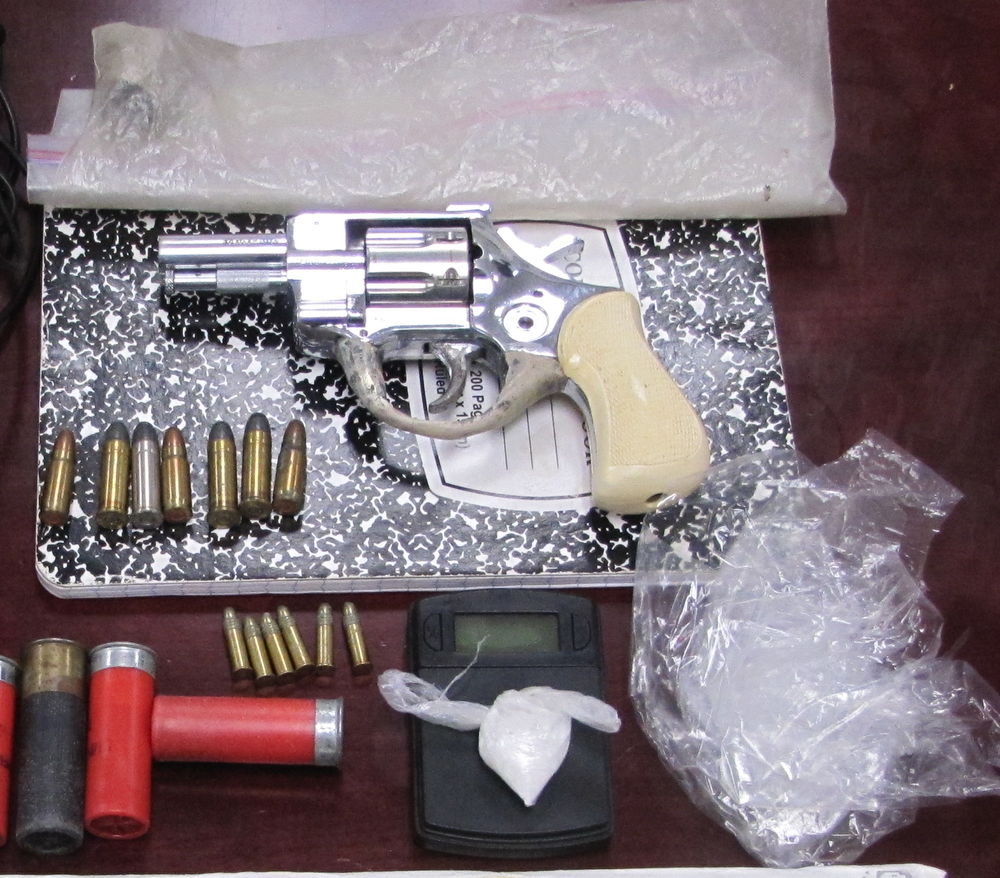 Image of gun and drugs. 