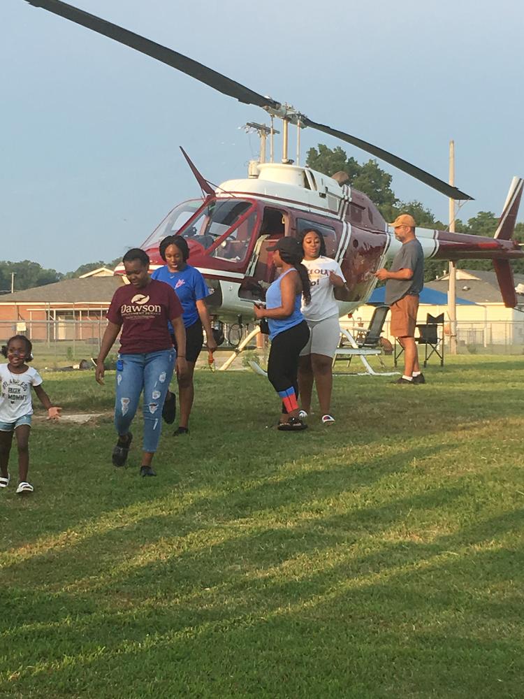 Photo of kids with helicopter. 